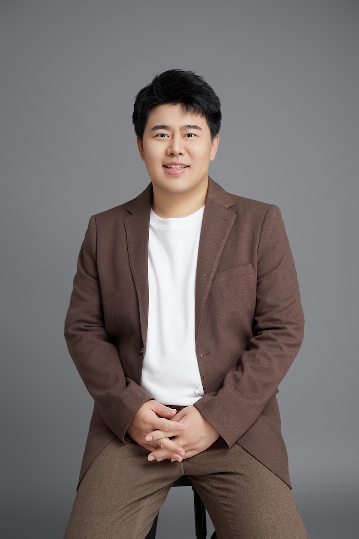 Professor in a brown blazer and white shirt