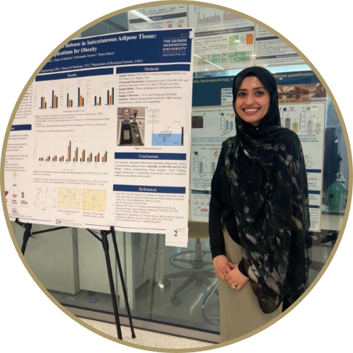 Student standing next to their project poster