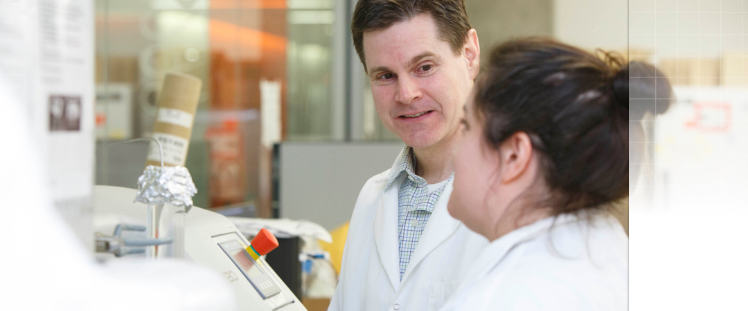 student and professor working in lab