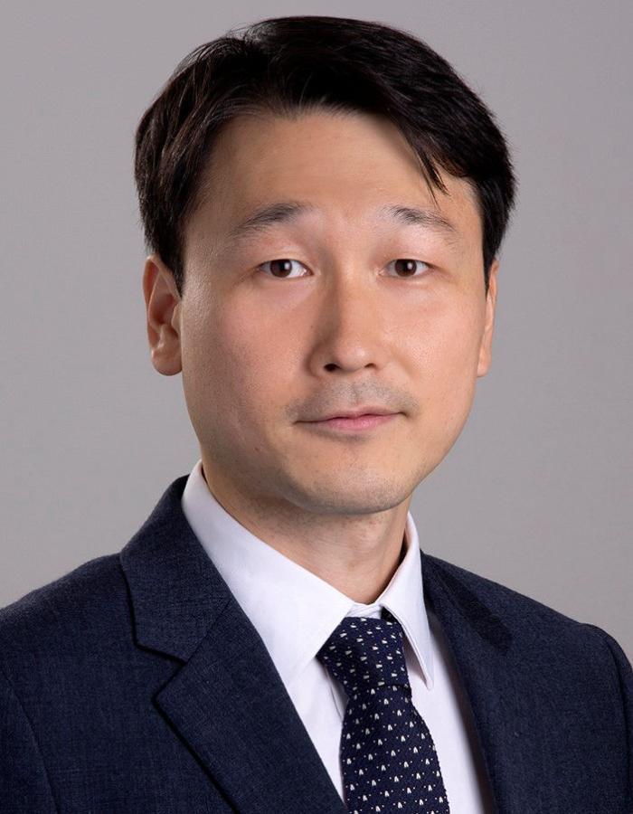 Professor in black suit and tie