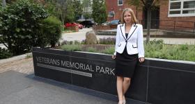 Sarah Malinowski in front of the Veterans Memorial Park sign