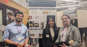 Students from the award-winning team standing in front of their research poster.